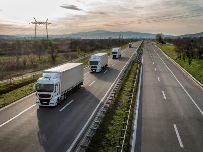 Caravan or convoy of trucks in line on a country highway